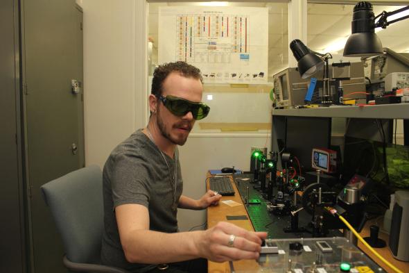 optics and photonics student working with machinery